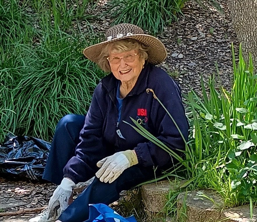 lady sitting in garden surrounded by plants
